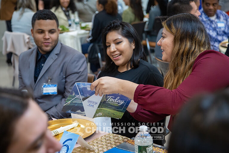 New members looking at a church booklet.
