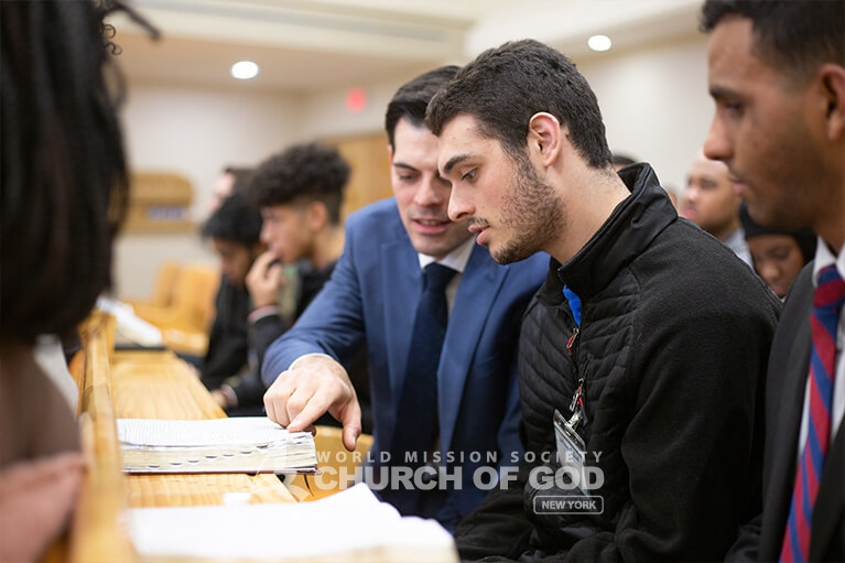 New members intently looking at the Bible during the group Bible study.